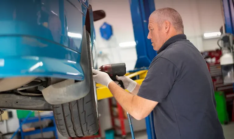 European car mechanic inspecting a luxury vehicle in Croydon workshop
