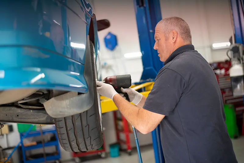 European car mechanic inspecting a luxury vehicle in Croydon workshop