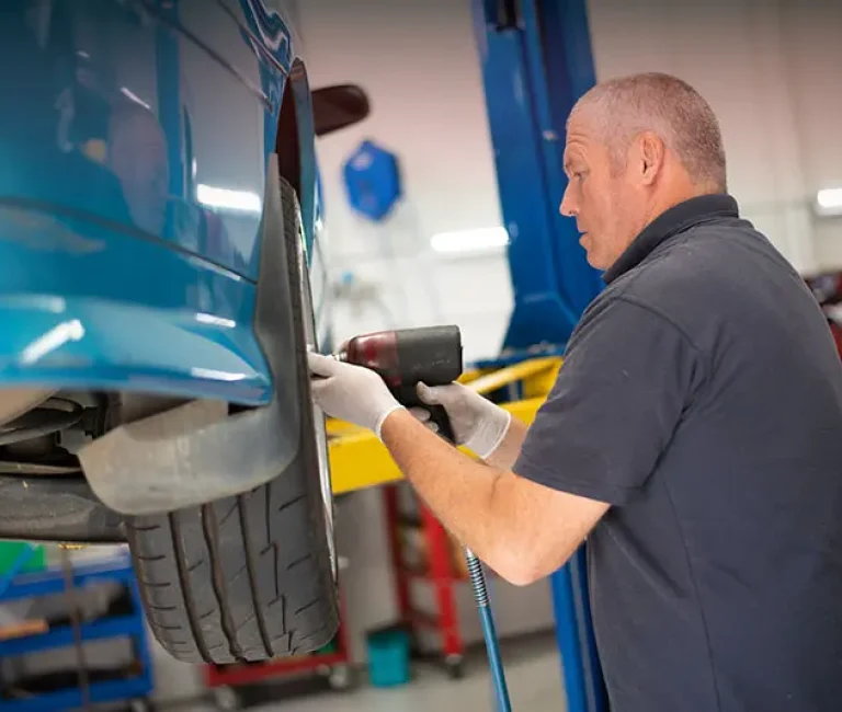 European car mechanic inspecting a luxury vehicle in Croydon workshop
